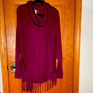 Soft poncho style / fringe runs up to left side